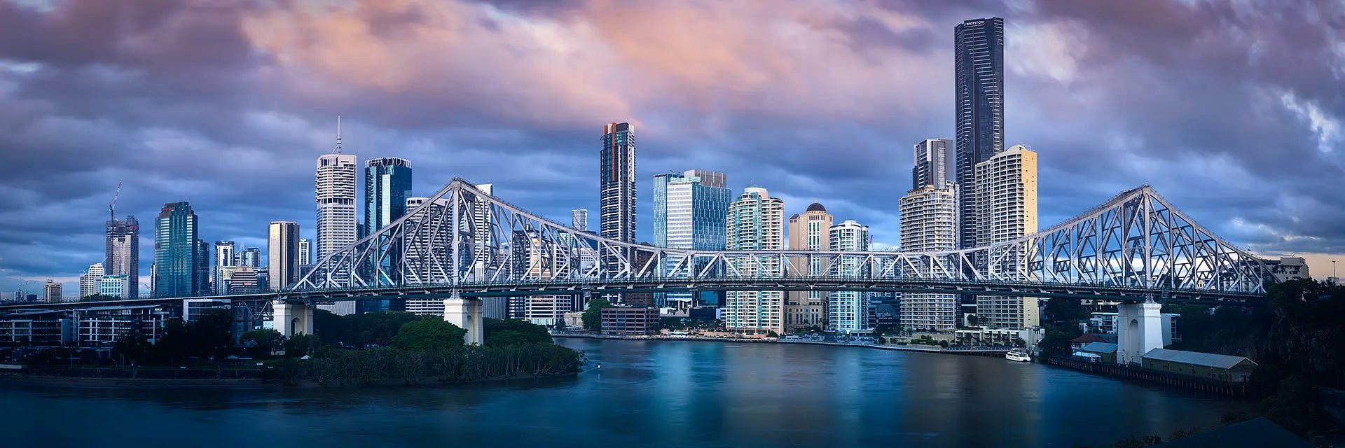 A city skyline and bridge at dusk